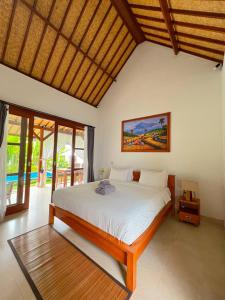 a bedroom with a large bed in a room at Good Karma House Ubud in Ubud