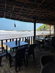 a restaurant on the beach with tables and chairs at Absolute paradise Kudle beach in Gokarna +15 photos