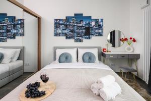 a bedroom with a bed with a glass of wine at Lumina Premium Apartments with view on center Warsaw in Warsaw