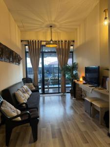 a living room with a couch and a tv at Zero Gravity Homestay 零重力民宿 in Semporna