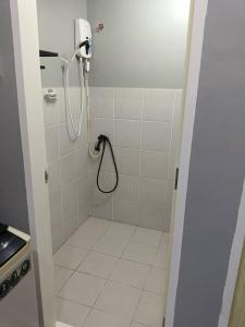 a bathroom with a shower with a shower head at AISY HOMESTAY KULIM/LUNAS in Kulim