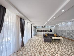 a living room with a couch and a table at Villa Della Mardakan in Mərdəkan
