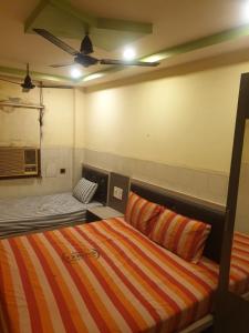 钦奈sam galaxy guest house的一间设有床铺和沙发的房间