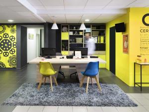an office with yellow and blue chairs and a desk at Aparthotel Adagio Access Strasbourg Petite France in Strasbourg