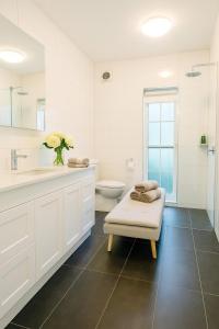 a white bathroom with a sink and a toilet at Exclusive Toorak Village 3B Corporate Retreat in Melbourne