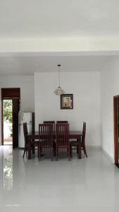 a dining room with a table and chairs and a refrigerator at River way in Ratnapura +23 photos