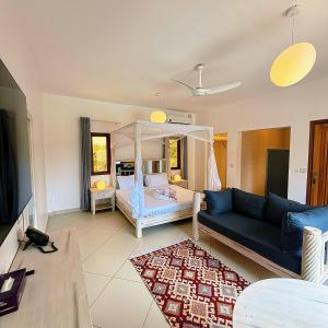 a living room with a bed and a couch at Jumeirah Malindi Hotel in Malindi +37 photos