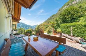 a wooden table and chairs on a patio with mountains at Melcherhof in Trodena