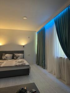 a bedroom with a bed and a large window at Гагарина 119 in Dnipro