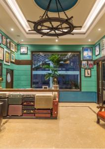 a bar with green walls and a chandelier at Polo Floatel Kolkata in Kolkata