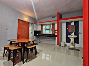 a dining room with a table and chairs and a piano at Zawa Home stay,coorg in Madikeri