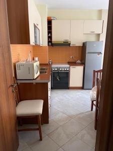 a small kitchen with a microwave on a counter at 1Bedroom Apt in Tirana - Close to Scanderbeg Square in Tirane +3 photos