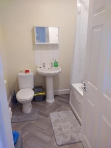 a bathroom with a white toilet and a sink at Bentley View in Crewe +14 photos