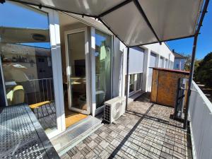 a screened in porch of a house at Luxury Penthouse 15 Min to Wiesn with Parking, Balcony in Munich