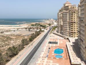 a view of the beach from the balcony of a building at Royal Breeze Sea View One Bedroom Apartment in Ras al Khaimah