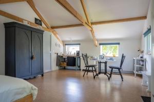 a bedroom with a bed and a table and chairs at De Heerlijkheid in Groenlo