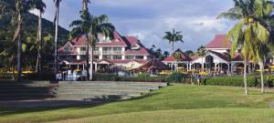 a resort with palm trees in front of a building at Studio Saint Vincent 13 in Sainte-Luce