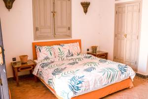 a bedroom with a bed and two night stands at Casa Zitouni - Oasis with pool & private personal in Marrakech +38 photos