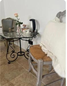 a bedroom with a table and a bed and a table with a chair at Maison 1838 