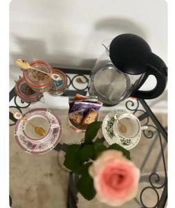 a table with a tea pot and dishes on it at Maison 1838 
