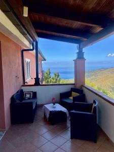 a balcony with couches and a table with a view at Cilento in San Mauro Cilento