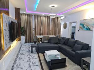 a living room with a couch and a table at Flat 1 Jonah Heights, Cluster 4, RiverParkEstate in Abuja