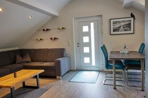 a living room with a couch and a table at Schwarzer Kater Blankenheim in Blankenheim