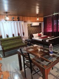 a living room with a couch and a table at Tea vista holiday home in Kalpetta