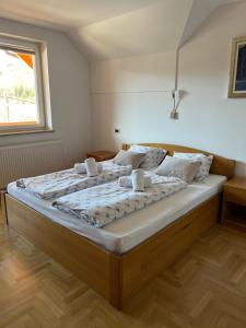 a large bed in a room with a window at Apartment Brumec in Bohinj