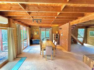 a dining room with a wooden table and chairs at Grampians Bush Retreat in Halls Gap
