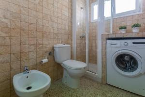 a bathroom with a toilet and a washing machine at Cozy Apartment in Salinetas Beach. in Salinetas +16 photos