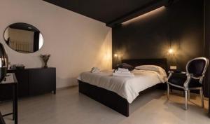 a bedroom with a bed and a mirror and a chair at Residenza Marcelli in Isernia
