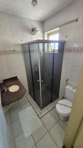 a bathroom with a shower and a toilet at Vinte Park Hotel in Bragança Paulista