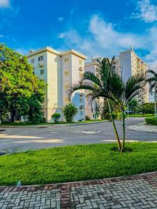 a palm tree in front of a building at Remarkable 5-Bed Apartment in Kilamba - Luanda in Luanda