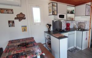 a kitchen with white cabinets and a counter top at Chalet à la campagne chez Sabine in Saint-Beauzire +3 photos