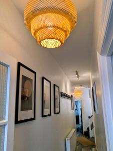 a large chandelier hanging from a wall with pictures at Bournemouth Beach Boutique with Hot Tub in Bournemouth +37 photos