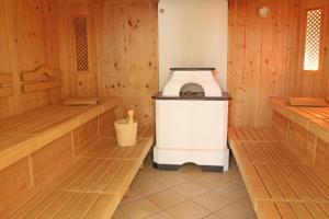 a kitchen with wooden walls and a stove in a room at die Harmonie in Nauders +6 photos