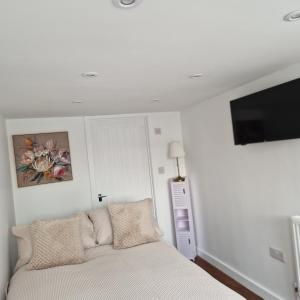 a bedroom with a bed and a flat screen tv at Welcoming ensuite bedroom in Wolverhampton
