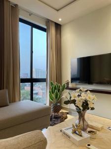 a living room with a couch and a large window at Luxury U Can See Compert U can feel Apartments in Gulburg III in Lahore +31 photos