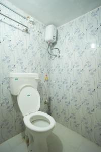a bathroom with a white toilet in a room at LeBeach Villa, Luxurious Stay Opposite Auroville Beach, ECR Road in Kuilapayam