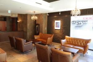 a waiting room with leather chairs and tables at Hotel WBF Sapporo Chuo in Sapporo