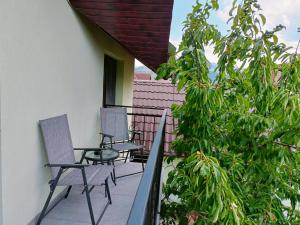two chairs sitting on the balcony of a house at Colț de lavandă in Braşov