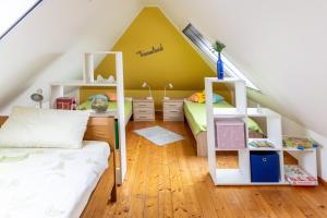 a room with two bunk beds and a yellow wall at Ferienwohnungen Schoofs in Kalkar +34 photos