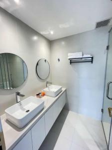 a white bathroom with a sink and a mirror at Classic homestay in Thôn Trường Giang