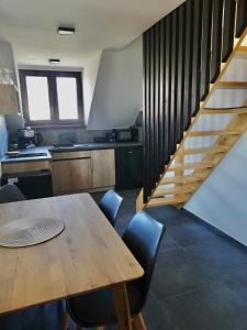 a kitchen with a wooden table and a staircase at Ubytování Pálava Perná in Perná +23 photos