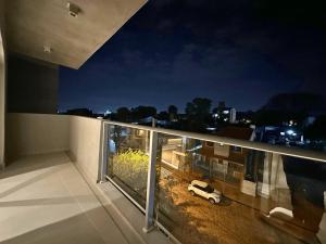 a white car parked on a balcony at night at ABIBA Apart-Hotel & SPA in Asunción
