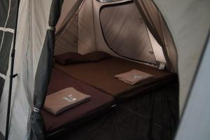 a small tent with two beds in it at Finest Camp in Cibogo