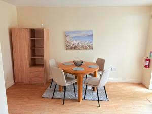 a dining room with a wooden table and chairs at The Lake in Portlaoise