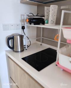 a kitchen with a tea kettle on a counter at Homez Sky Cerrado Southville in Kampung Dengkil