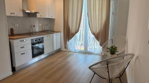 a kitchen with a table and two chairs and a window at Framira House - Elegant Room tra Centro e Fiera in Bologna